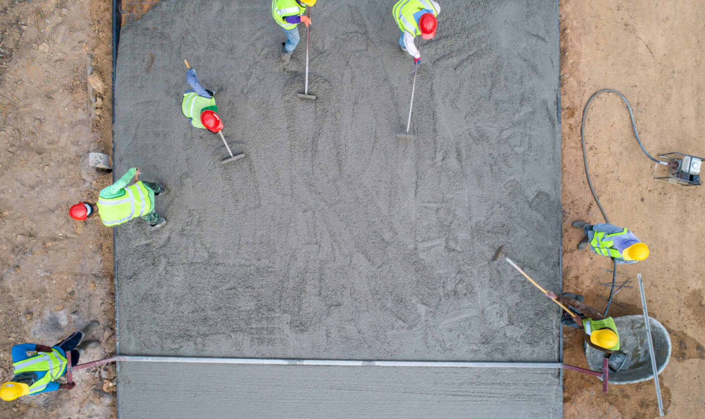 A,Construction,Worker,Pouring,A,Wet,Concret,At,Road,Construction